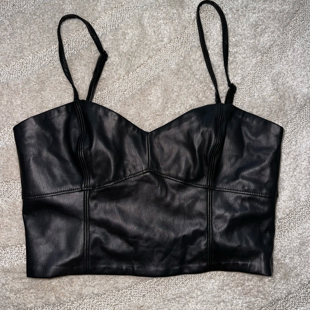 Black leather crop top with adjustable straps.